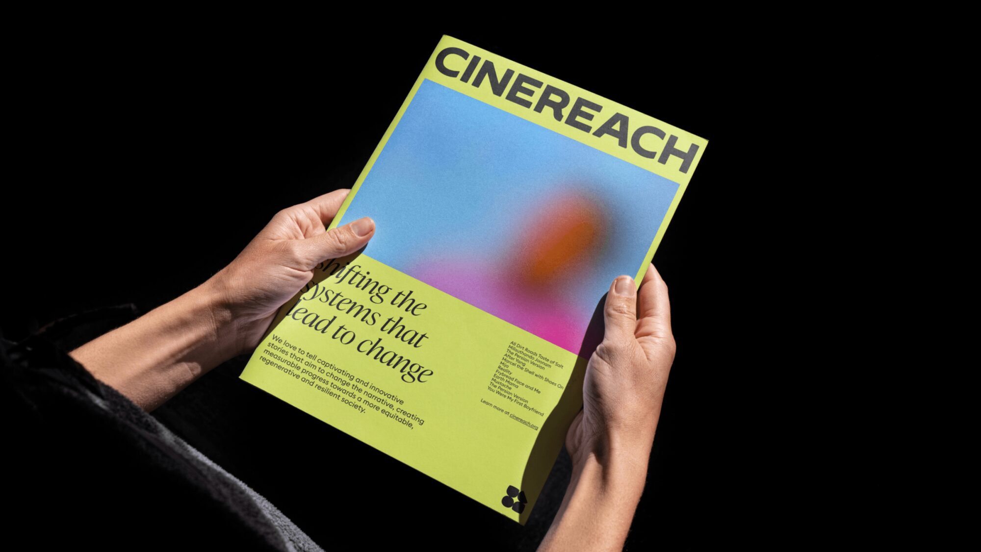 The Cinereach brand as it might look on a magazine cover. Two hands hold the magazine as though someone is reading it intently.