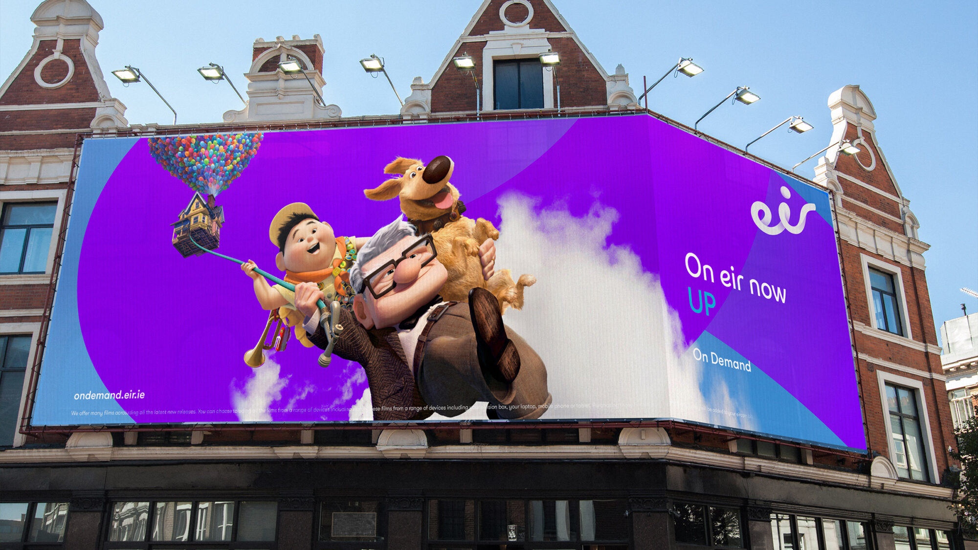 A huge branded billboard on a building that features a scene from the Pixar animated film 'Up' and the words 