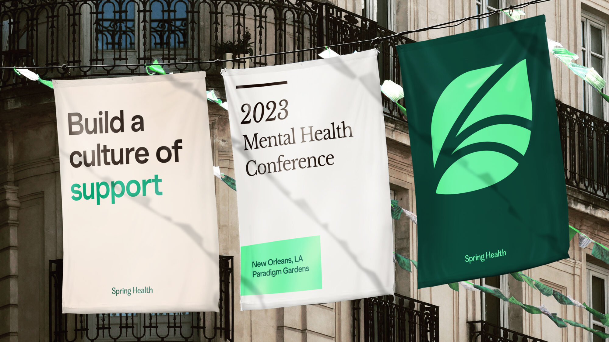 A street with three graphic Spring Health posters for the 2023 Mental Health Conference. The posters feature the Spring Health logo and the title “Build a culture of support”