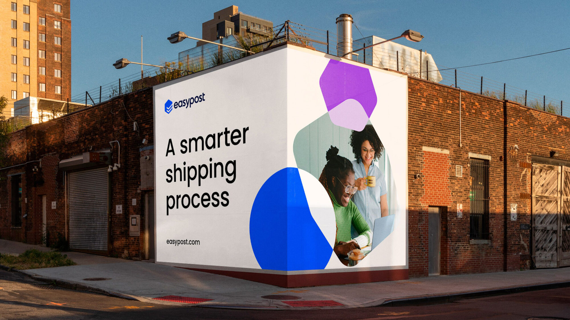 A billboard advertising a smarter shipping process. It sits on the corner of a building, giving it the feeling of a square package.